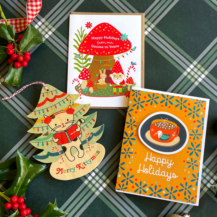 Real wood ornament holiday card shaped like a tree with a white kitty cat singing carols and a white holiday card with festive red mushroom and a forest scene with rabbit, gnome birds and candy canes. Gnome for the holidays.