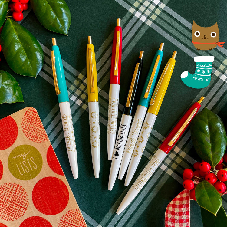 Click pens with aqua, red, yellow and black caps with gold or black messages on the barrel. Fun styles read "Magic Wand", "Getting Stuff Done", I (heart) Making Lists" and a pen with sunny happy faces and shooting stars.