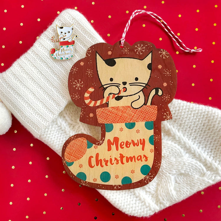 Real wood ornament card die cut in the shape of a tree. Shows both the front and back side of the card with ample room to write a greeting. Design features cute beaver with stocking hat holding a present in front of green holiday tree.
