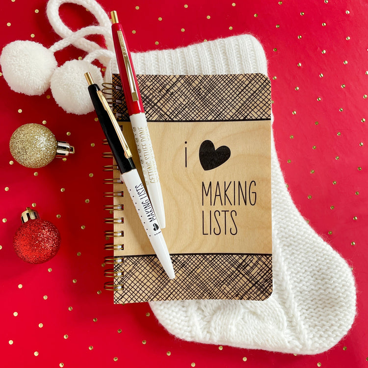Real wood cover pocket-size notebook with black text 'I love making lists'  love is a black heart symbol cute modern folksy design with black cross hatch pattern and 2 ballpoint click pens. with text ' I (heart) making lists' and 'Getting Stuff Done' 
