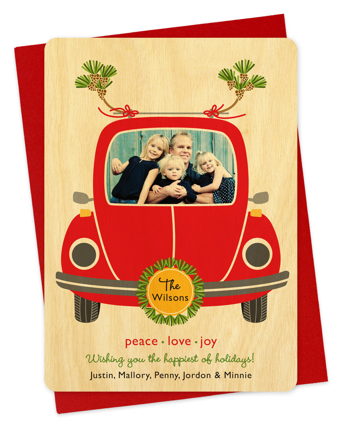 Customizable wood holiday card featuring your photo in the windshield of a red car. Features family name on the license plate and a personal greeting at the bottom of the card. Shown on a red envelope.