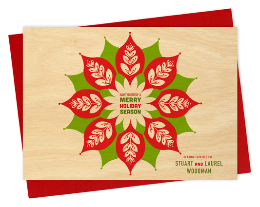 Customizable paper holiday card with red and green leaf design, "Have Yourself a Merry Holiday Season" greeting and a personal message on a printed birch wood background. Shown with a red envelope.