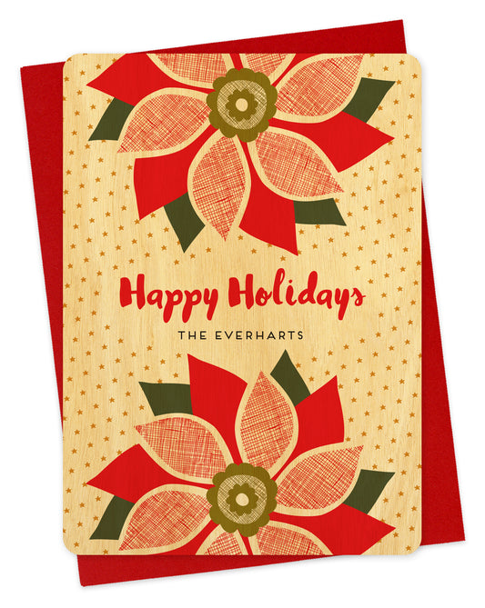 Customizable birch wood holiday card with red poinsettias, “Happy Holidays” text and a personal message on a background filled with small gold stars. Shown with a red envelope.