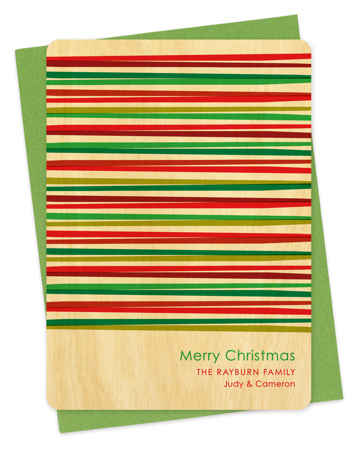 Customizable birch wood Christmas card with horizontal stripes in various shades of red and green and a personal greeting. Shown with a green envelope.