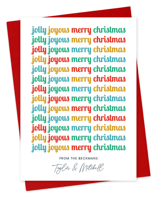 Customizable paper holiday card featuring cheerful, multicolored “Jolly Joyous Merry Christmas” text repeated down the length of the card and a personal greeting at the bottom. Background of card is white. Shown with a red envelope.