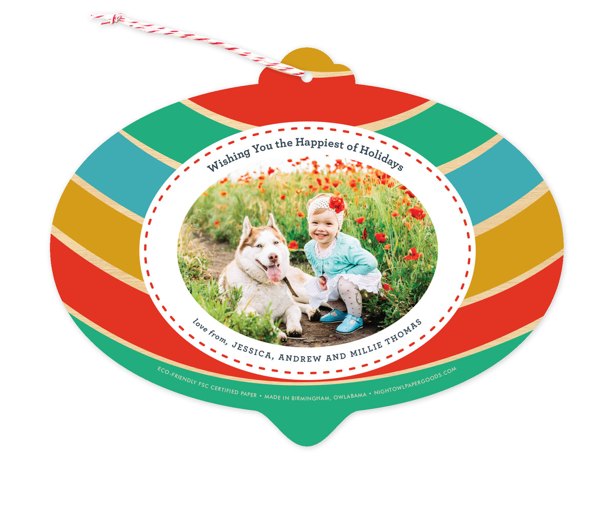 Back of customizable bulb-shaped paper holiday ornament card with Photo + Text Back option showing a personal photo and message bordered by bold, colorful stripes.