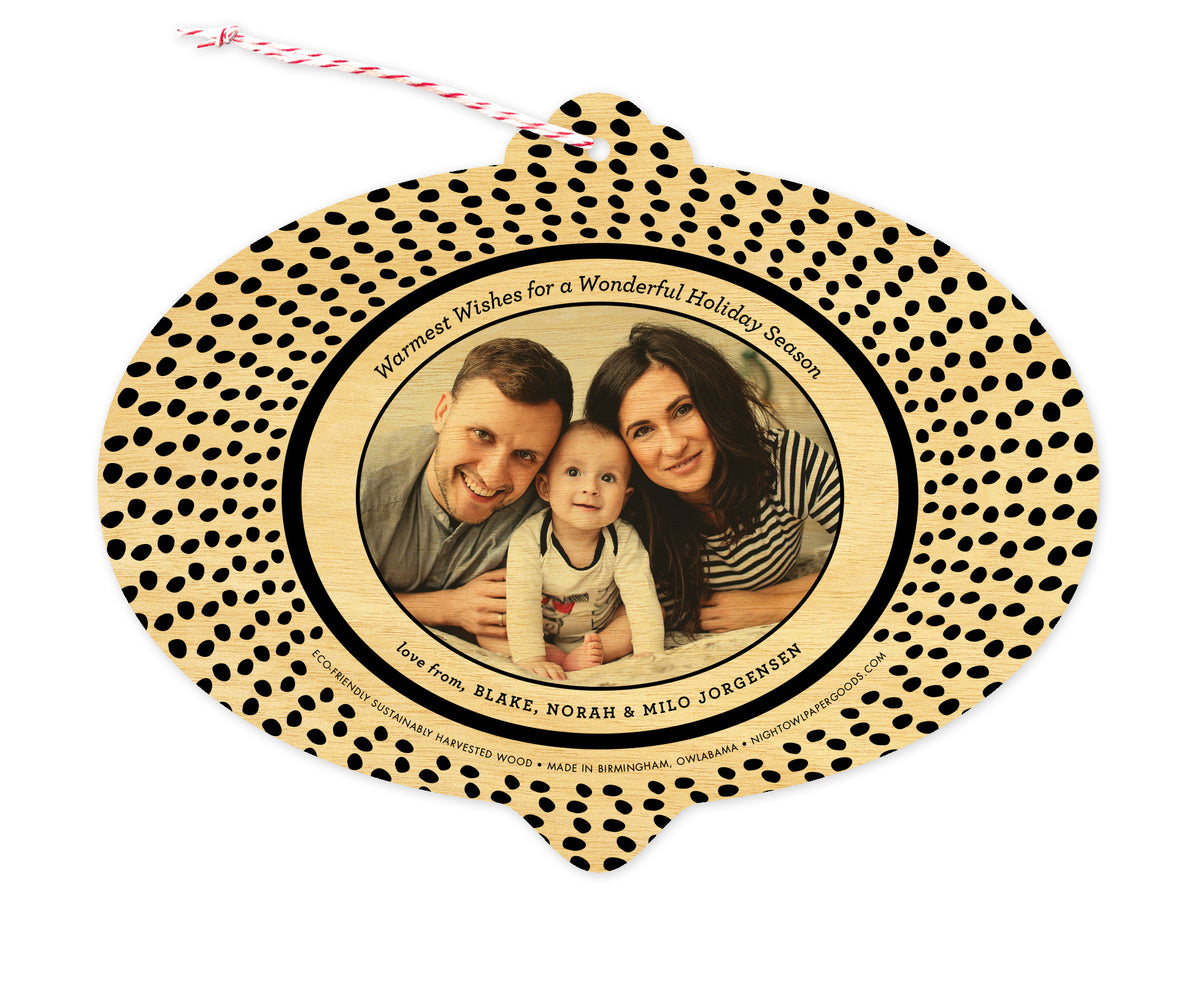Back of customizable bulb-shaped wood holiday ornament card with Photo + Text Back option showing a personal photo and message bordered by black speckles.