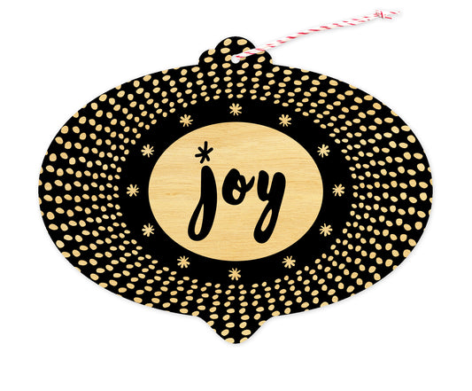 Front of bulb-shaped birch wood holiday ornament card with black-and-white pattern and “Joy” greeting.