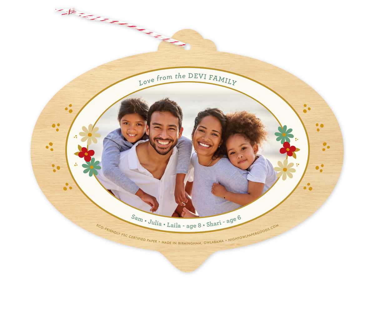 Back of customizable bulb-shaped paper holiday ornament card with Photo + Text Back option showing a personal photo and message accented by several small flowers and a printed birch wood grain border.