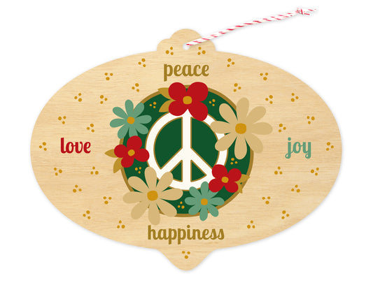 Front of bulb-shaped paper holiday ornament card with floral peace sign and “peace, love, joy, happiness” text on a printed birch wood grain background.