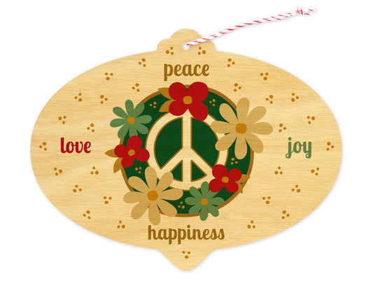 Front of bulb-shaped holiday ornament card on birch wood with floral peace sign and “peace, love, joy, happiness” text.