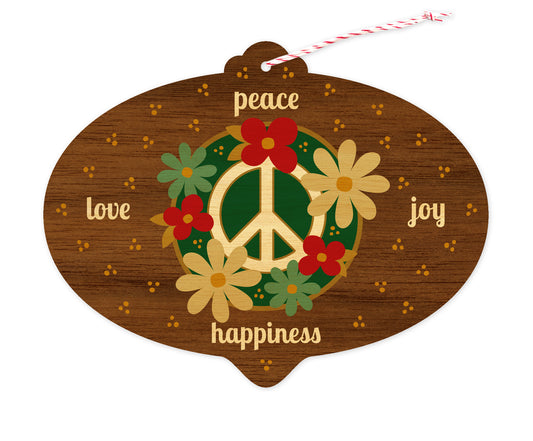 Front of bulb-shaped wood holiday ornament card with floral peace sign and “peace, love, joy, happiness” text on a printed walnut wood grain background.