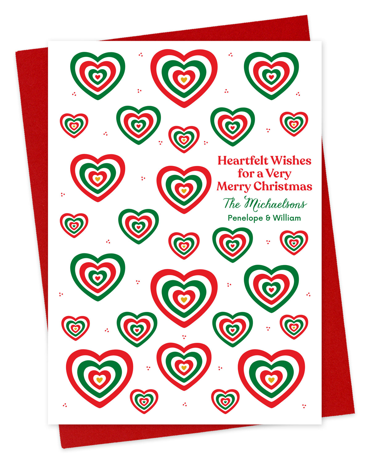 Customizable paper Christmas card with red and green heart patterns and a personal greeting on a white background. Shown with a red envelope.