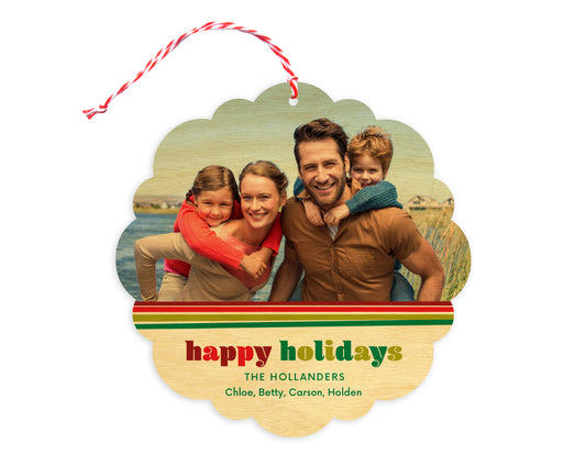 Front of customizable birch wood holiday ornament card featuring a photo with a festive red and green striped border, “Happy Holidays” text and a personal message. Round ornament with scalloped edges.