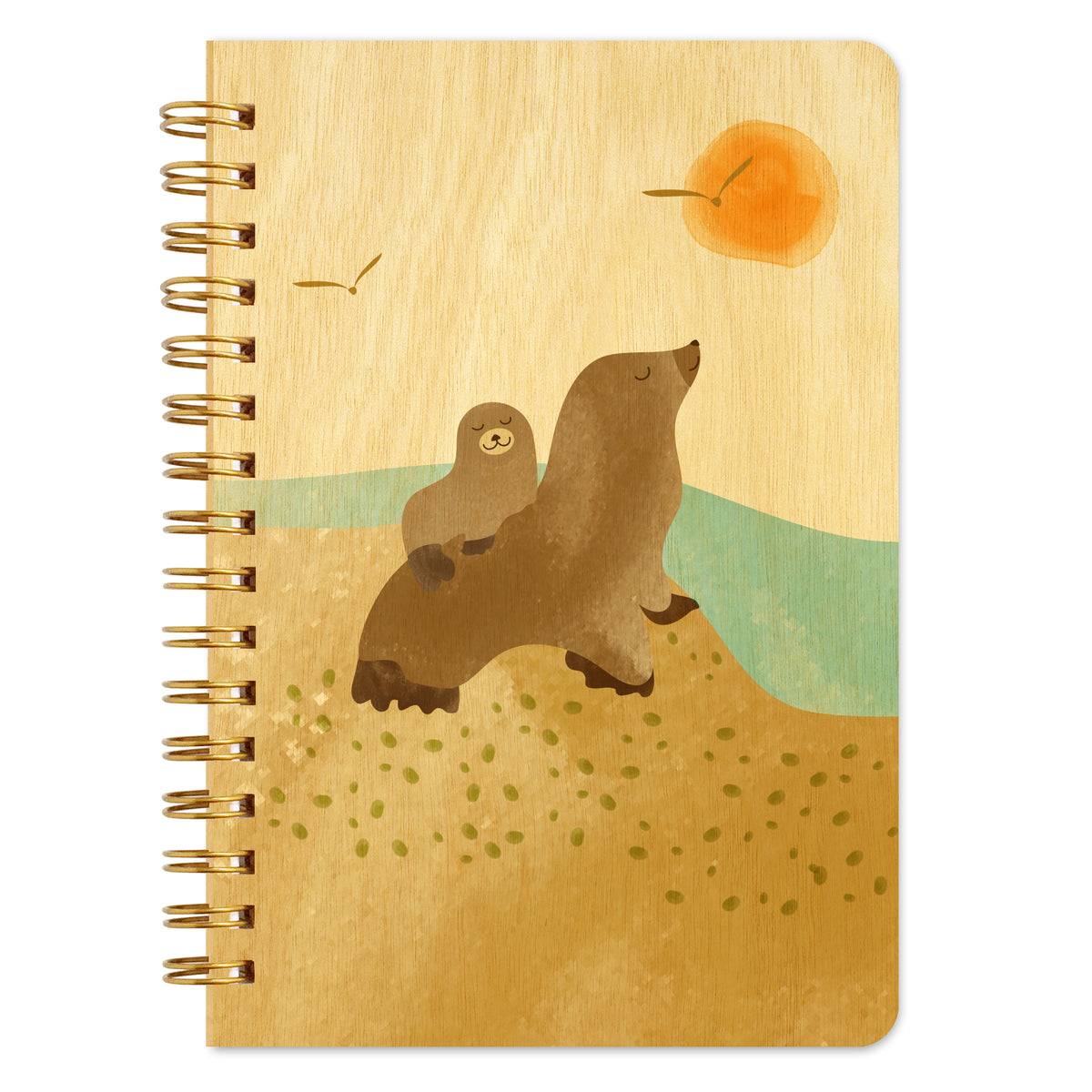 Spiral-bound wood notebook with birch wood covers featuring a sea lion pup riding on its mother’s back beside the ocean with seagulls and a setting sun.
