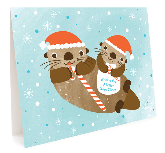 Lotter Otter folded holiday card featuring two otters wearing Santa hats and holding candy canes against a snowy light blue background. Text reads 'Wishing you a lotter good cheer'