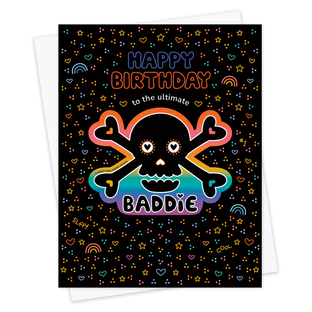 Front of birthday greeting card with a removable rainbow skull vinyl sticker and "Happy Birthday to the Ultimate Baddie" text surrounded by colorful rainbow, star, and heart designs on a black background. Shown with a white envelope.