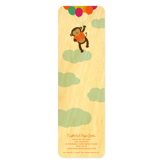 Back of birch wood bookmark with a monkey holding colorful balloons. At the bottom: Night Owl Paper Goods script logo with text reading "Made in the USA - Eco-Friendly Sustainably Harvested Wood - Visit us at nightowlpapergoods.mom."