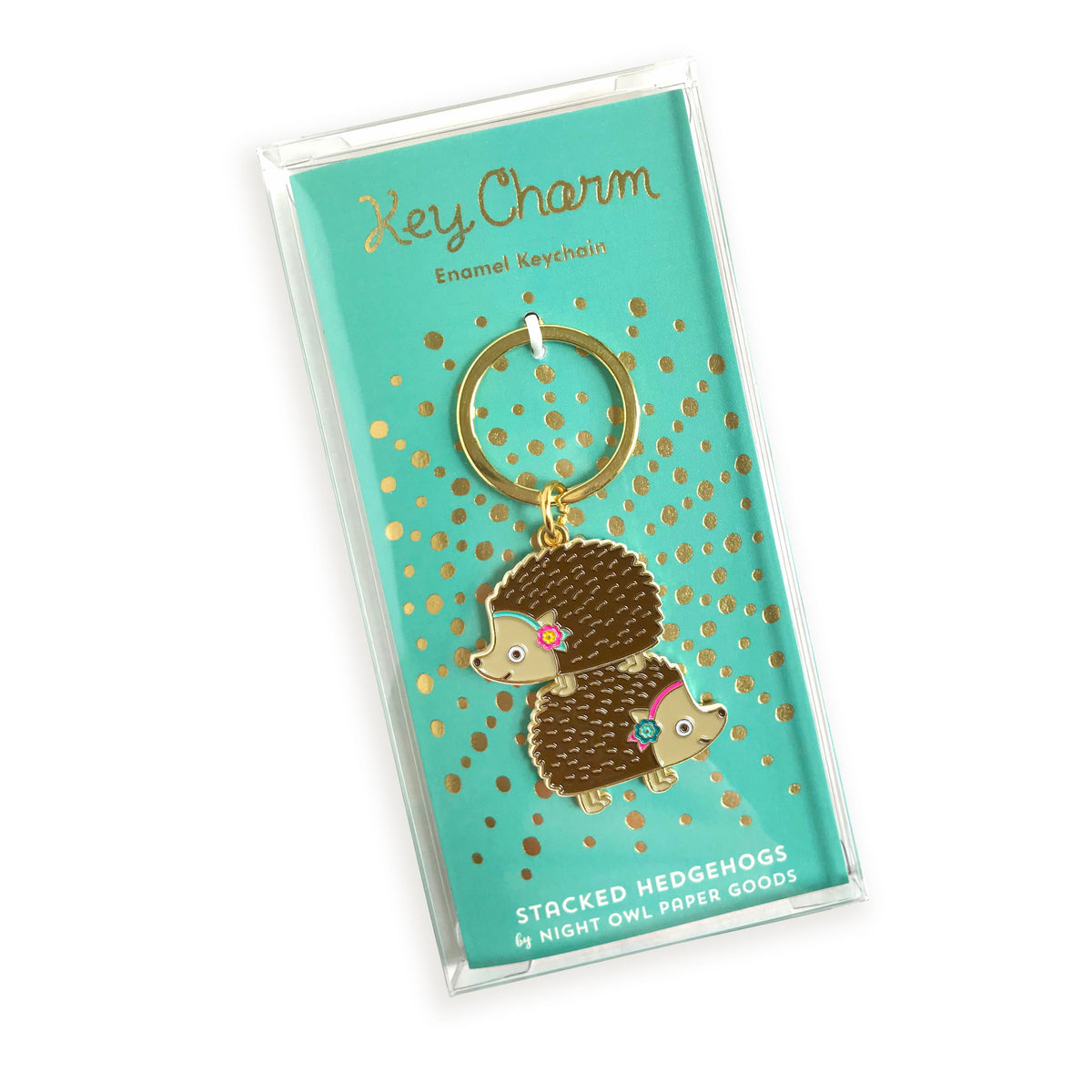 Stacked Hedgehogs enamel keychain on gold foil stamped backer card packaged in a clear gift box. Backer card reads "Key Charm Enamel Keychain" at top and "Stacked Hedgehogs by Night Owl Paper Goods" at bottom.