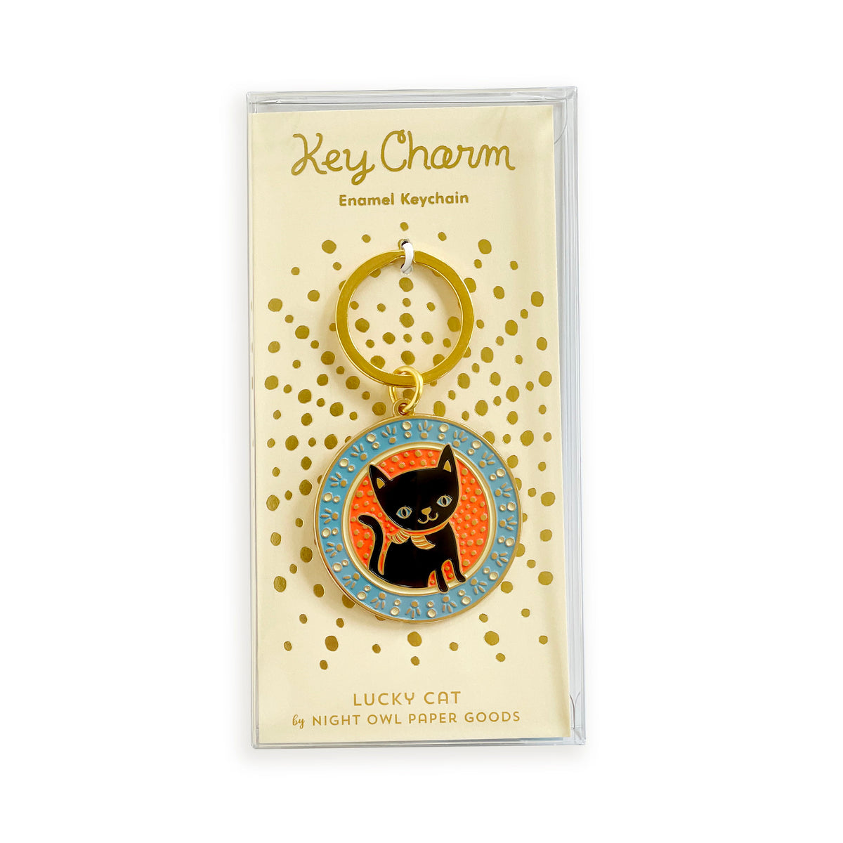 Black cat enamel keychain on gold foil stamped backer card packaged in a clear gift box. Pale yellow backer card reads "Key Charm Enamel Keychain" at top and "Lucky Cat by Night Owl Paper Goods" at bottom.