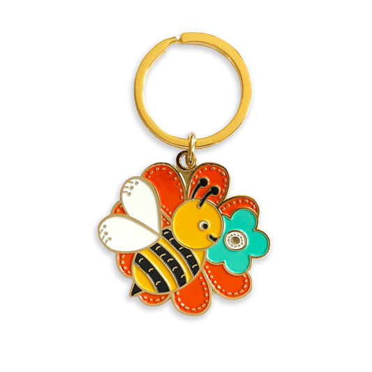 Gold metal bee and flower keychain with on a gold key ring