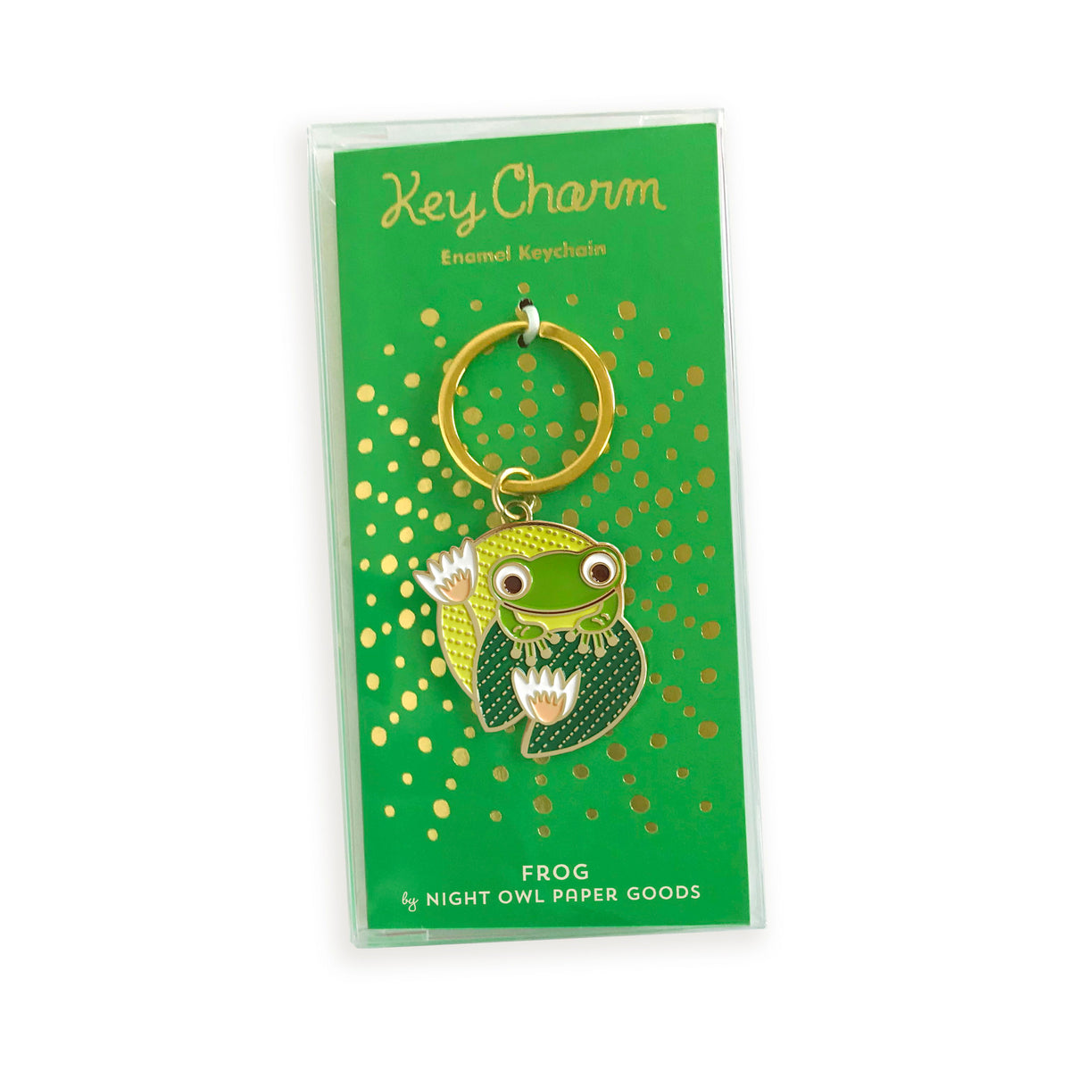 Frog enamel keychain on a gold foil stamped backer card packaged in a clear gift box. Kelly green backer card reads "Key Charm Enamel Keychain" at top and "Frog by Night Owl Paper Goods" at bottom.
