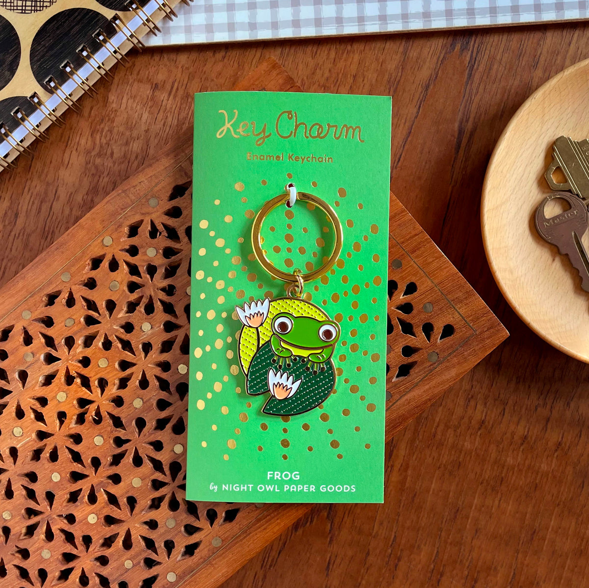 Frog enamel keychain on a gold foil stamped backer card. Kelly green backer card reads "Key Charm Enamel Keychain" at top and "Frog by Night Owl Paper Goods" at bottom.
