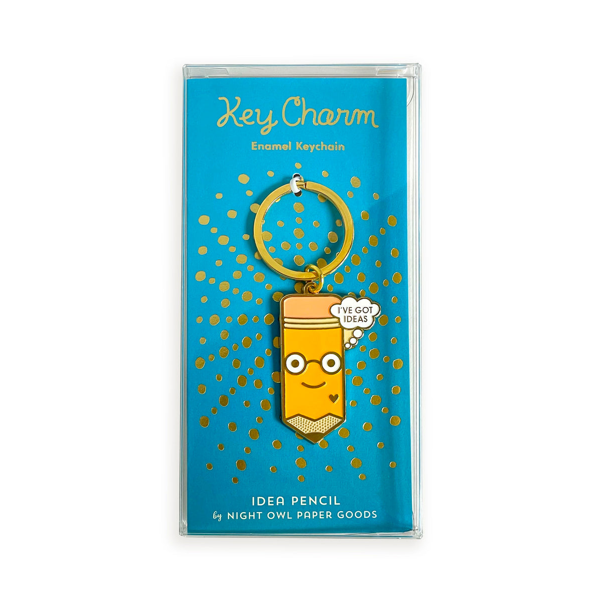 Idea Pencil enamel keychain on gold foil stamped teal backer card packaged in a clear gift box. Backer card reads "Key Charm Enamel Keychain" at top and "Idea Pencil by Night Owl Paper Goods" at bottom.

