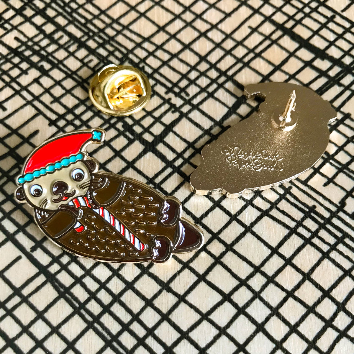 Santa Otter Enamel pin