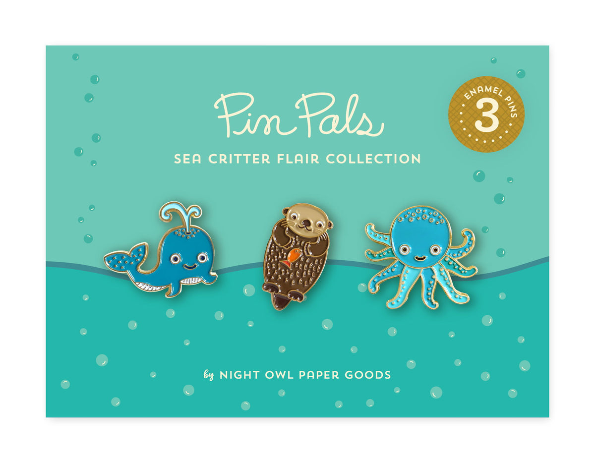 Sea Critter Flair Pin Pals Gift Set - Three enamel pins of an otter, a whale, and an octopus on an underwater themed backer card that reads "Pin Pals Sea Critter Flair Collection by Night Owl Paper Goods - 3 Enamel Pins"