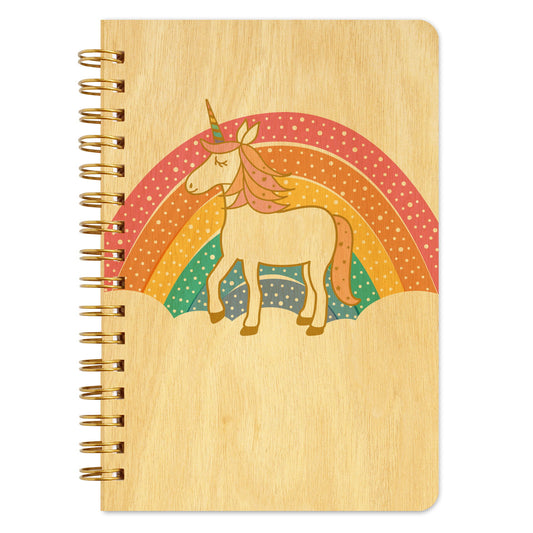 Spiral-bound wood notebook with birch wood covers featuring a unicorn with a pink and orange mane standing in front of a polka-dotted pastel rainbow.
