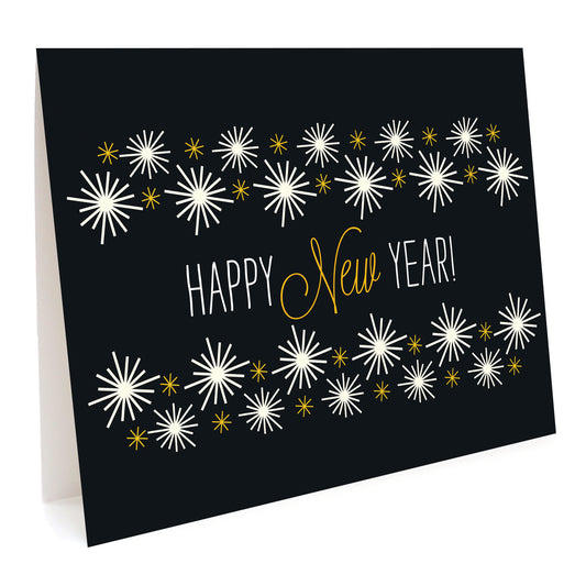Golden New Year folded paper holiday card featuring gold and white starburst fireworks on a black background with a "Happy New Year!" greeting