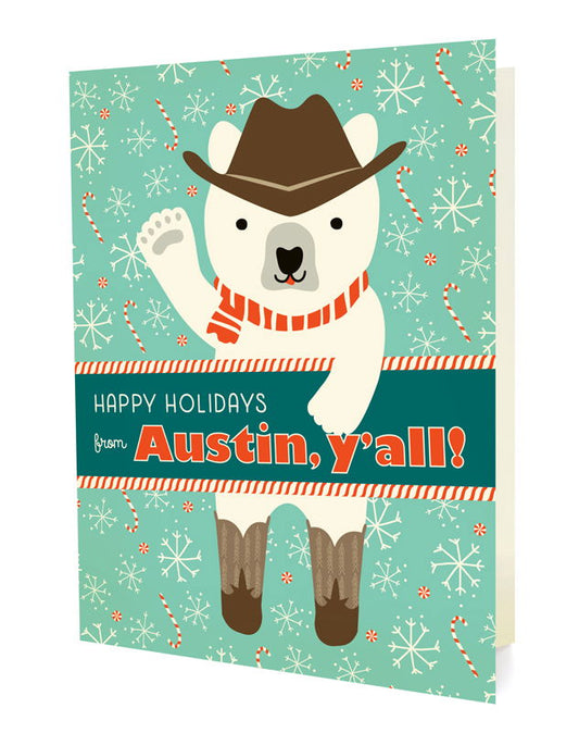Polar Austin folded paper holiday card featuring a polar bear in a cowboy hat, red striped scarf and cowboy boots waving against a teal background with snowflakes and candy canes and the greeting "Happy Holidays from Austin, y'all!"