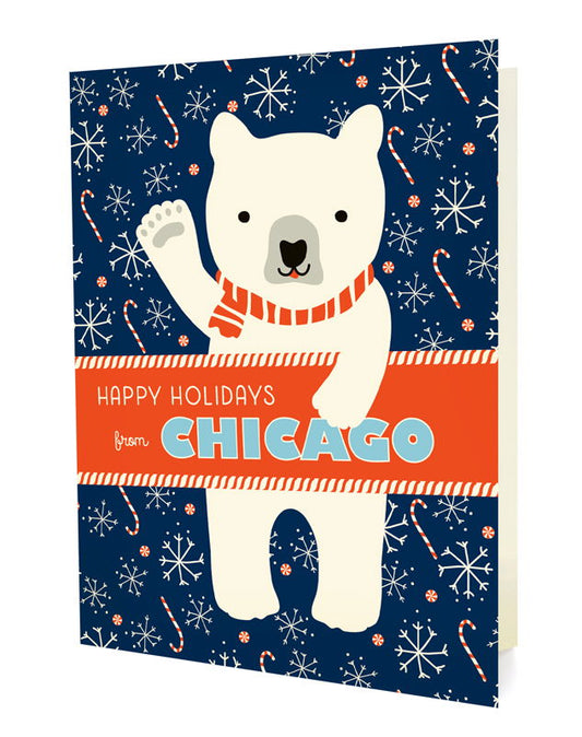 Polar Chicago folded paper holiday card featuring a polar bear in a red striped scarf waving against a navy blue background with snowflakes and candy canes and the greeting "Happy Holidays from Chicago"