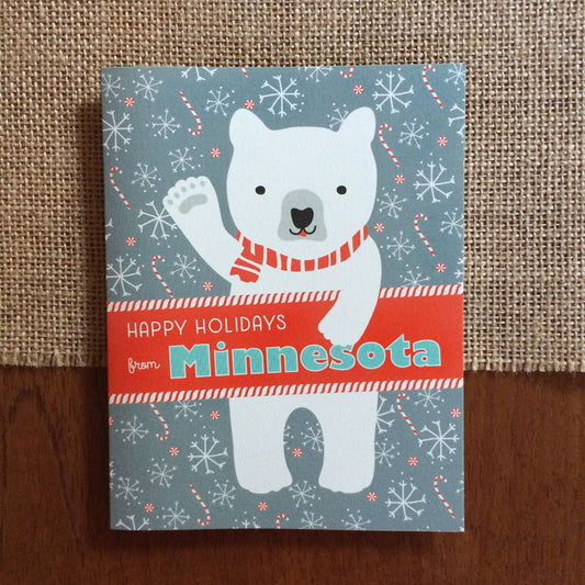 Polar Minnesota folded paper holiday card featuring a polar bear in a red striped scarf waving against a gray-blue background with snowflakes and candy canes and the greeting "Happy Holidays from Minnesota"