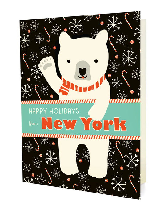 Polar New York folded paper holiday card featuring a polar bear in a red striped scarf waving against a black background with snowflakes and candy canes and the greeting "Happy Holidays from New York"