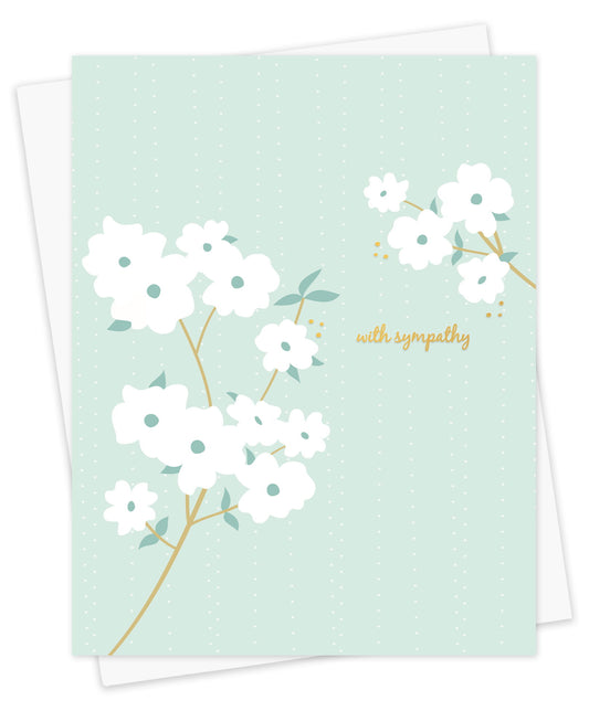 Sympathy card with white floral dogwood design, gold foil "with sympathy" message and subtle gold foil accents on a light blue background. Shown with a white envelope.
