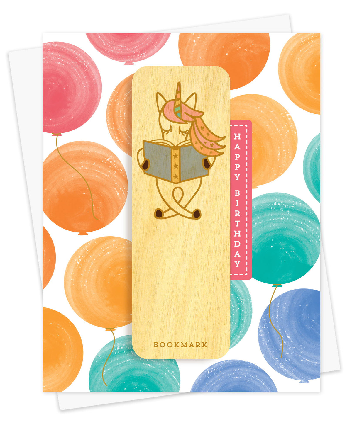 Folded birthday greeting card with watercolor balloons in pastel pink, orange, teal and blue, Happy Birthday text and a removable birch wood bookmark featuring a unicorn reading a book. Pictured with a white envelope.
