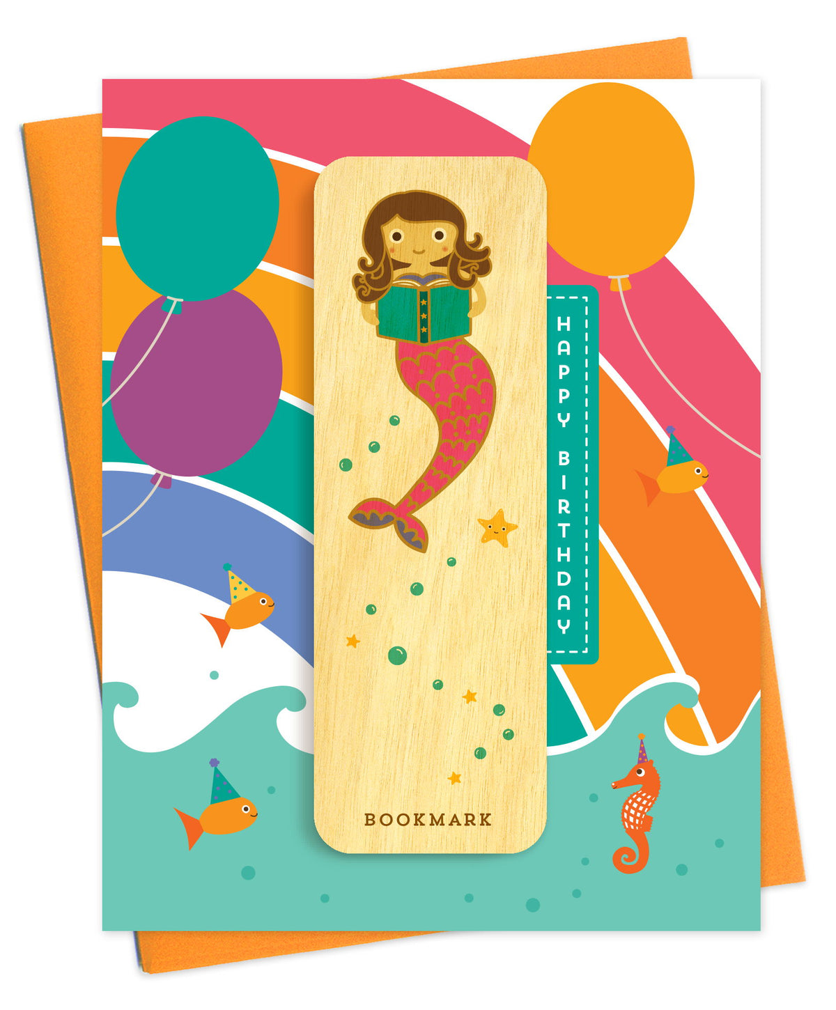 Folded birthday greeting card with colorful balloons, ocean waves, fish and a seahorse wearing party hats, Happy Birthday text and a removable birch wood bookmark featuring a mermaid reading a book. Pictured with an orange envelope.