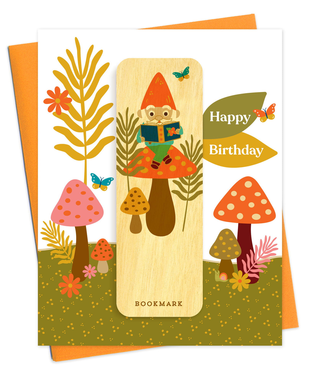 Folded birthday greeting card with a whimsical woodland mushroom scene, Happy Birthday text and a removable birch wood bookmark featuring an illustrated gnome reading a book. Pictured with an orange envelope.