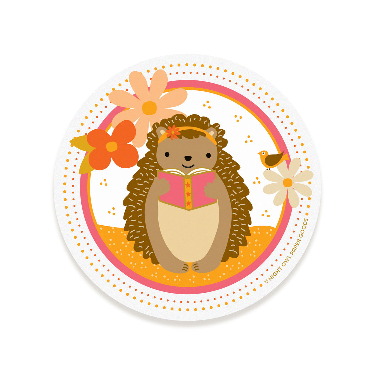 Round vinyl sticker featuring a hedgehog reading a book, surrounded by flowers and a bird on a white background.