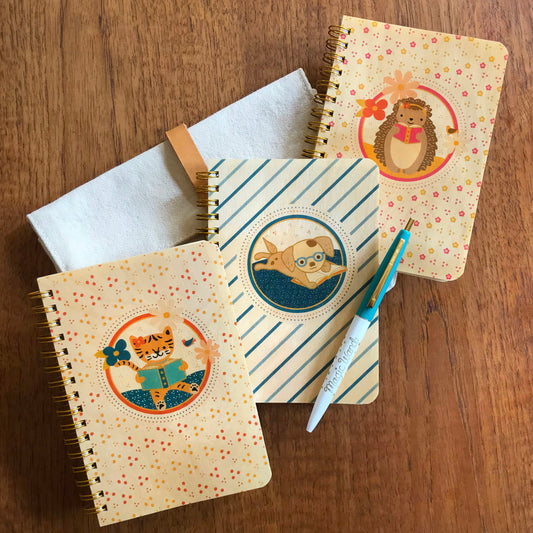 Set of three notebooks with wood covers featuring reading animal illustrations.