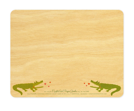 Back of No Croc wood love card, which is predominantly blank for a handwritten personal greeting. Along the bottom are two small crocodiles, the company logo and text that reads "eco-friendly sustainably harvested wood - made in the usa - birmingham, owlabama - nightowlpapergoods.mom"