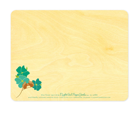 Back of Blue Flower Squirrels wood love card, which features a small version of the front design at in the lower left corner and plenty of space to write a personal greeting. Along the bottom is the company logo and text that reads "eco-friendly sustainably harvested wood - made in the usa - birmingham, owlabama - nightowlpapergoods.mom"