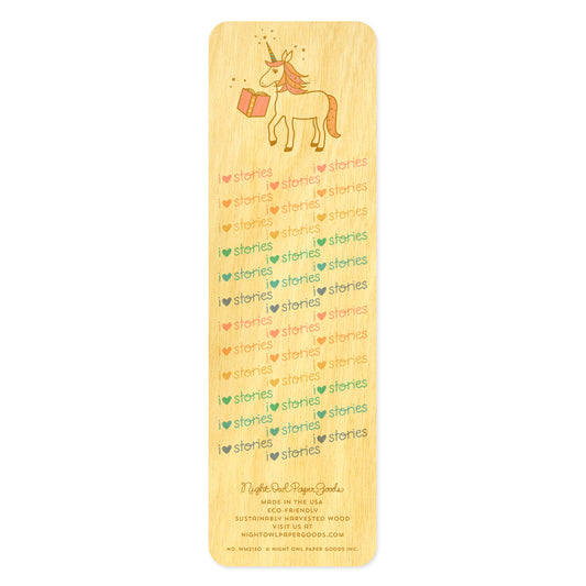 Back of birch wood bookmark with a unicorn and "I heart stories" text. At the bottom: Night Owl Paper Goods script logo with text reading "Made in the USA - Eco-Friendly Sustainably Harvested Wood - Visit us at nightowlpapergoods.mom."