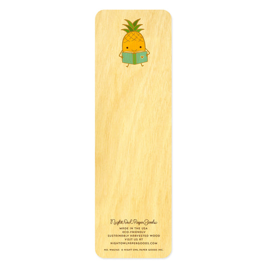 Back of birch wood bookmark with a pineapple sitting and reading a book. At the bottom: Night Owl Paper Goods script logo with text reading "Made in the USA - Eco-Friendly Sustainably Harvested Wood - Visit us at nightowlpapergoods.mom."