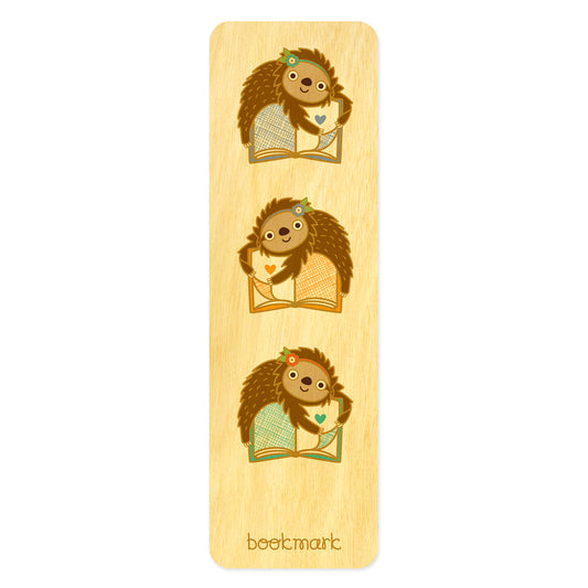 Wooden bookmark with three cute sloths hugging books. Text at bottom reads "bookmark." 